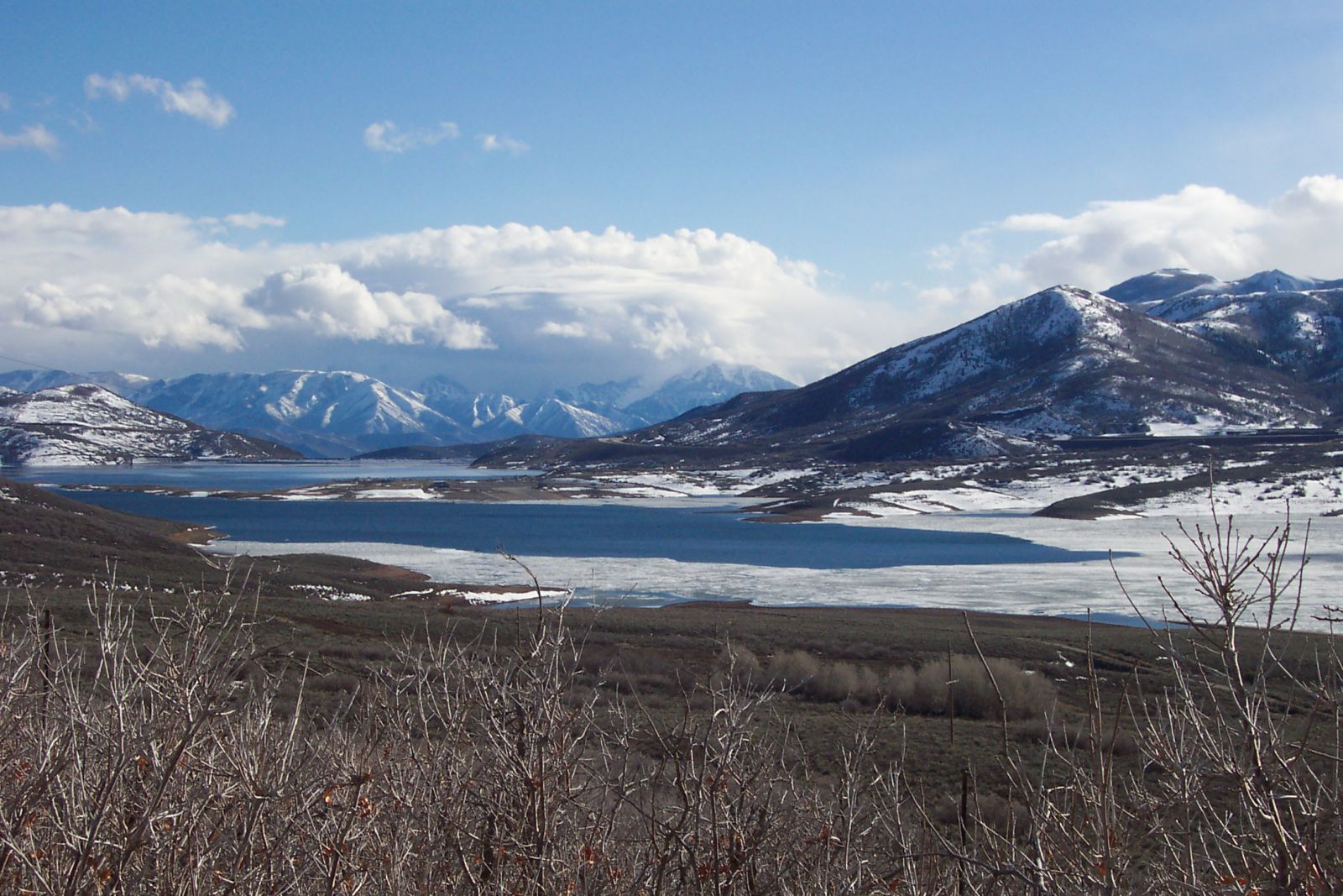 Overlooking the Jordanelle Reservoir with Park City and Deer Valley Ski Mountains in background.